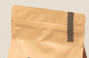 Press-to-close zipper closure on a specialty coffee bag showing resealable mechanism for home and cafe use